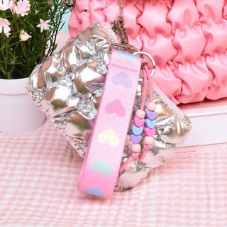 Quilted metallic silver bag charm with keychain pouch and heart-print wrist strap for kids