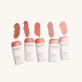 Five Oceany blush tubes with swatches of lip color on a white background
