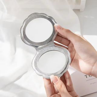 Clam shell compact mirror with foldable seashell design and dual-sided 1x and 2x magnification, ideal mermaid makeup tool for kids