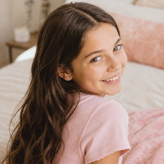 Girl using Eco Glam Girl Star Dusted refillable lip gloss