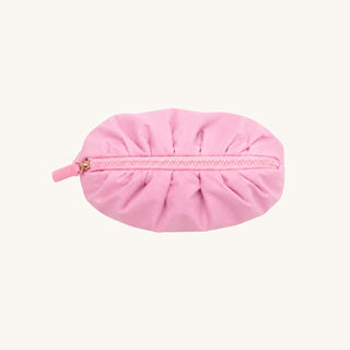 Pink puffer accessory bag viewed from above with gathered zipper