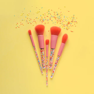 Kids makeup brushes with sprinkles in a 5-piece set, stored in a clear snap case for fun and organized beauty play