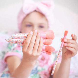 Kids makeup brushes with sprinkles in a 5-piece set, stored in a clear snap case for fun and organized beauty play