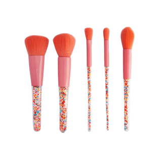 Kids makeup brushes with sprinkles in a 5-piece set, stored in a clear snap case for fun and organized beauty play
