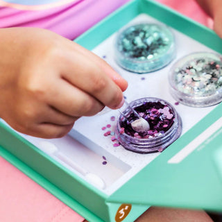 Mermaid glitter kit with three ocean-inspired biodegradable glitter for face shades, natural glue primer, and reusable magnetic-closing box for eco-friendly sparkle