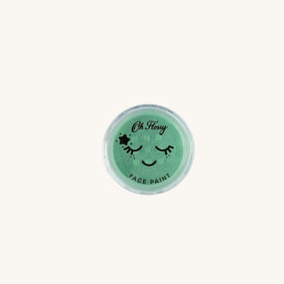 Green face paint container with a smiley face design on a white background