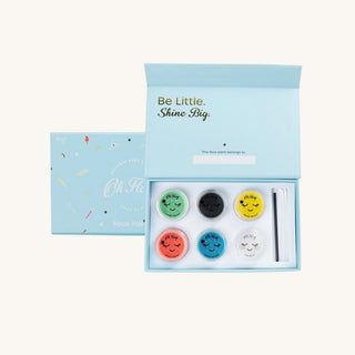 Makeup set with colorful face paint designs in a light blue box on a white background