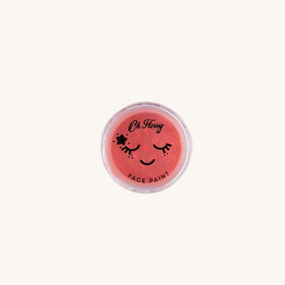 Red face paint container with 'Oh Flossy' branding on a white background