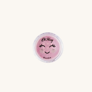 Pink blush container with a smiley face design on a white background