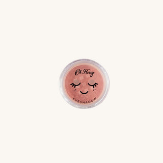 Peach eyeshadow compact with 'Oh Flossy' branding on a white background