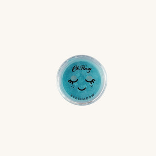 Blue eyeshadow container with a smiley face design on a white background