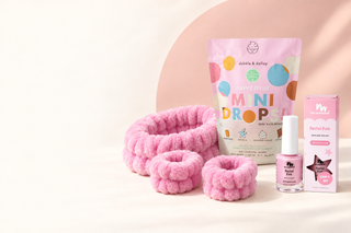 Pink Spa Day Set with Dabble & Dollop Sweet Treat bath bombs, a pink spa headband and two wrist cuffs, and No Nasties pink nail polish.