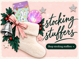Stocking stuffers — fluffy cream stocking, mermaid nail stickers and an iridescent clamshell mirror on pale pink. Shop stocking stuffers.