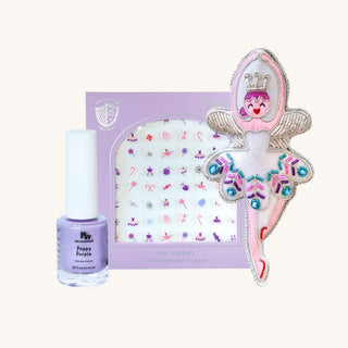 Sugarplum nail stickers in lavender packaging beside a beaded fairy ornament and Poppy Purple nail polish on a cream background.